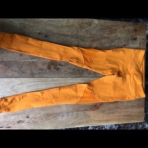 ALO yoga pants in bright yellow - over the heel